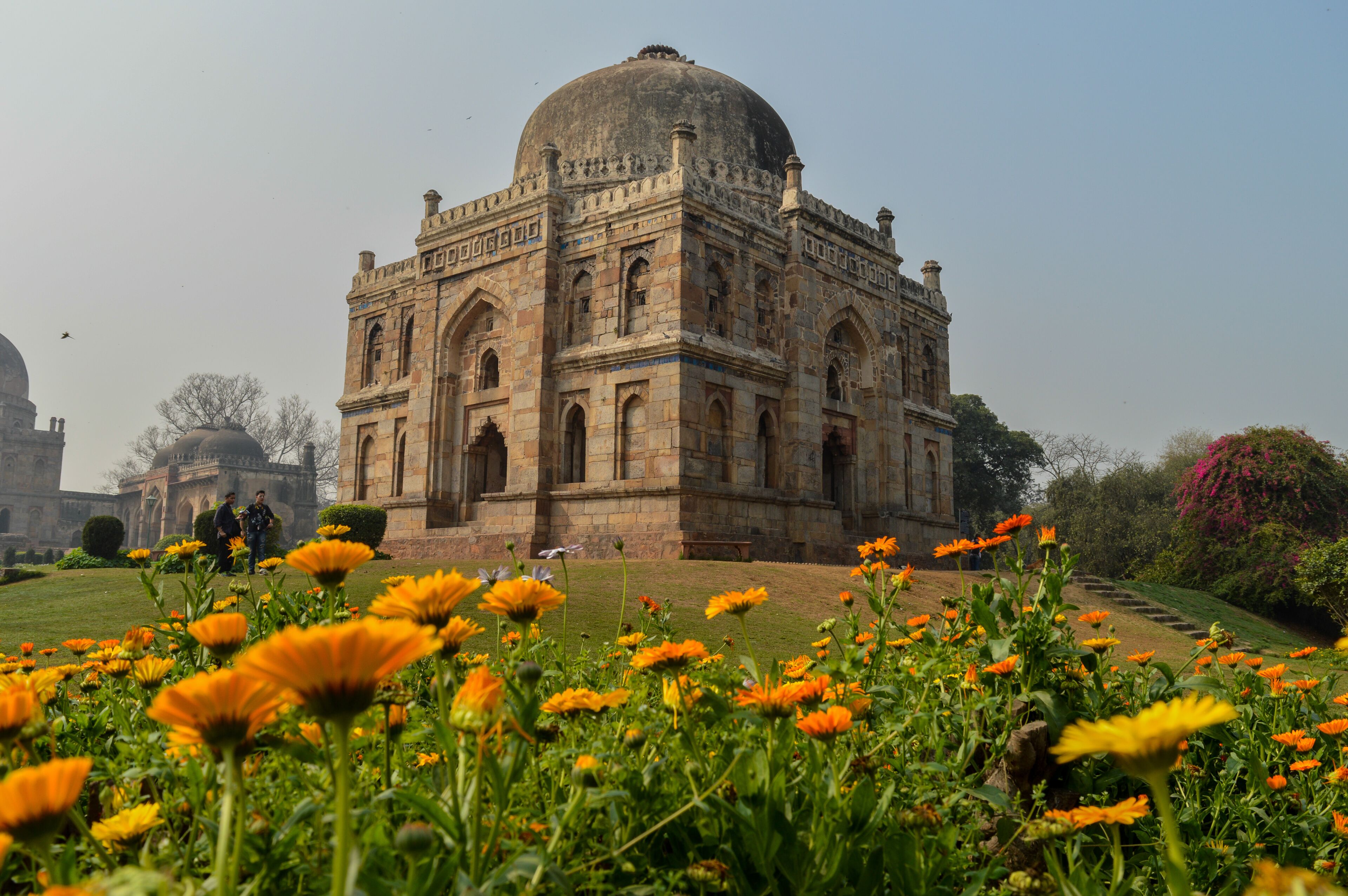 Shish Gumbad in Lodhi Garden, Delhi, behind a bed of orange marigolds